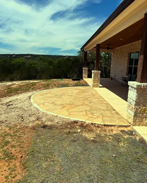 Curved flagstone patio joining a limestone porch, looking out over the Texas Hill Country