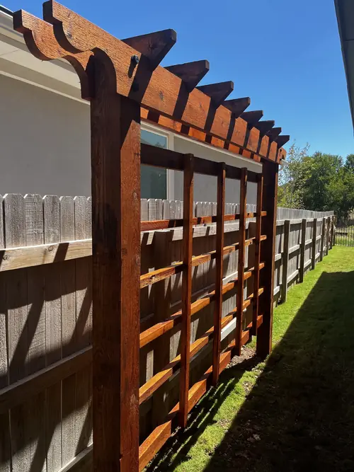 Cedar arbour and lattice screen running the length of a side yard