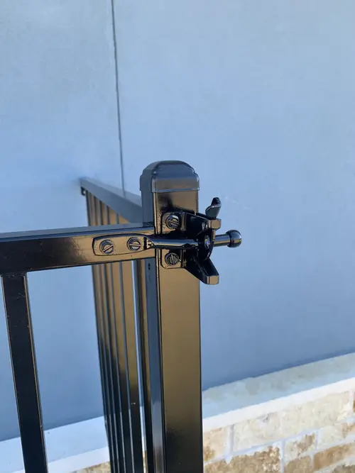 Detail of the latch and gate post on the steel guard rail