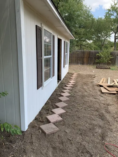 Paver stepping-stone path set along the side of a home
